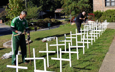 Dept. Grand Knight and Warden Bryan Clark putting up crosses